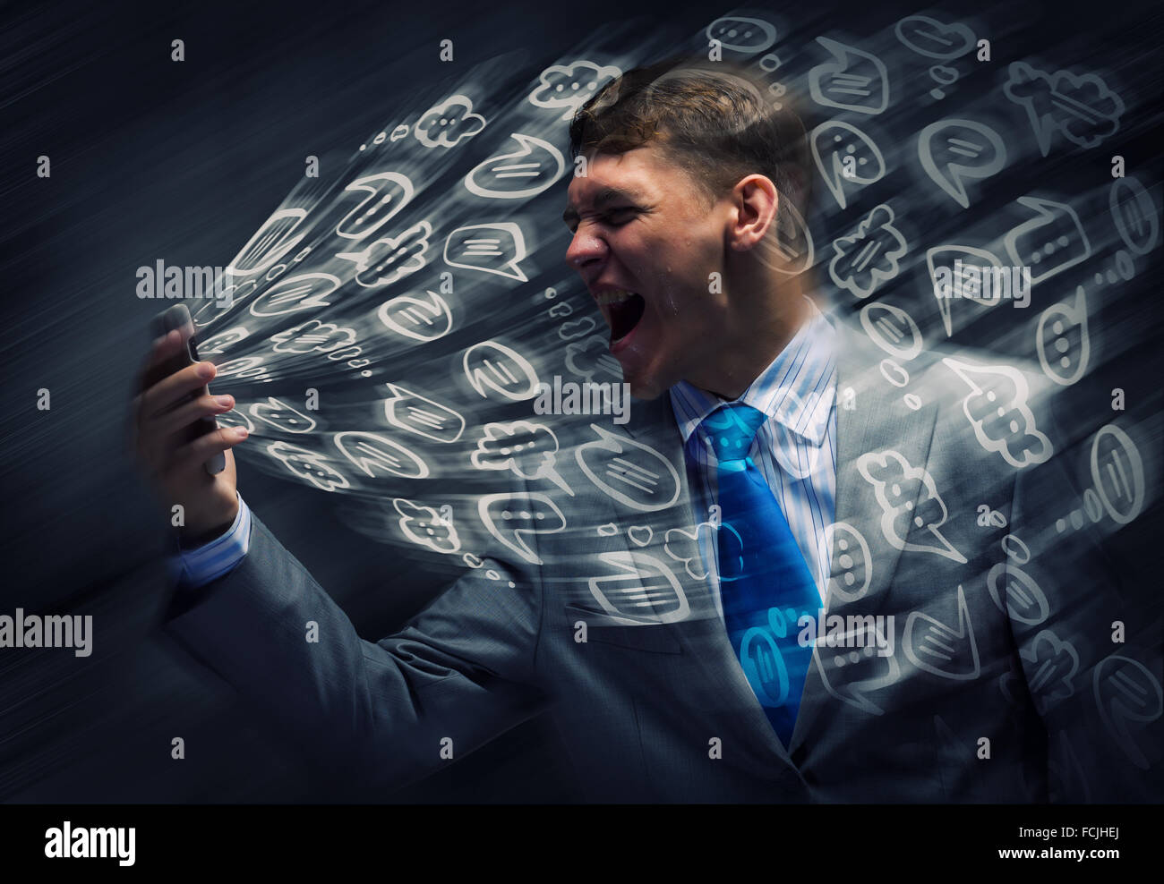 Angry businessman screaming furiously in mobile phone Stock Photo