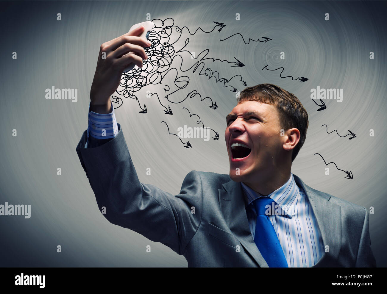 Angry businessman screaming furiously in mobile phone Stock Photo