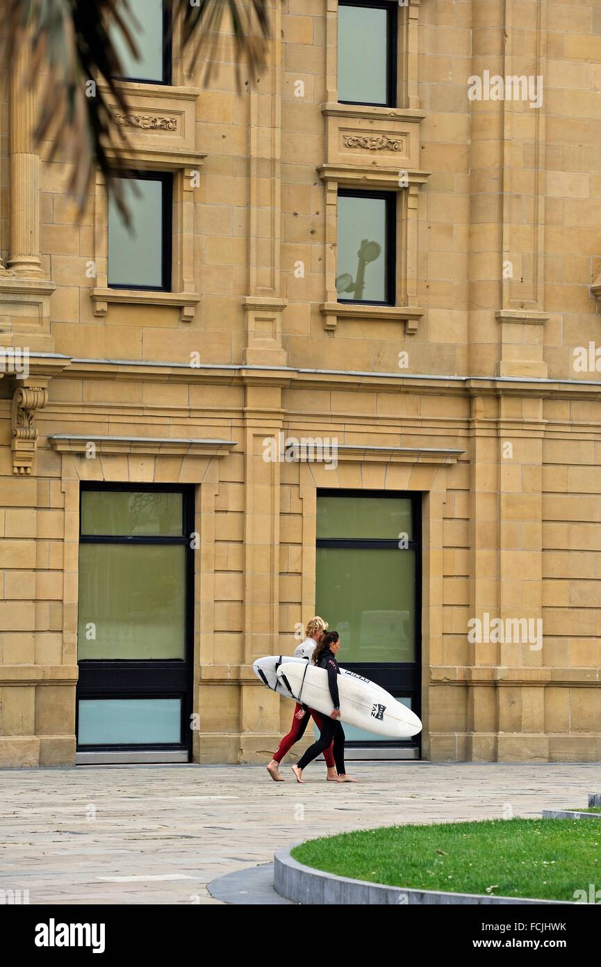 surfers passing in front of the Victoria Eugenia Theatre, San Sebastian, Bay of Biscay, province
