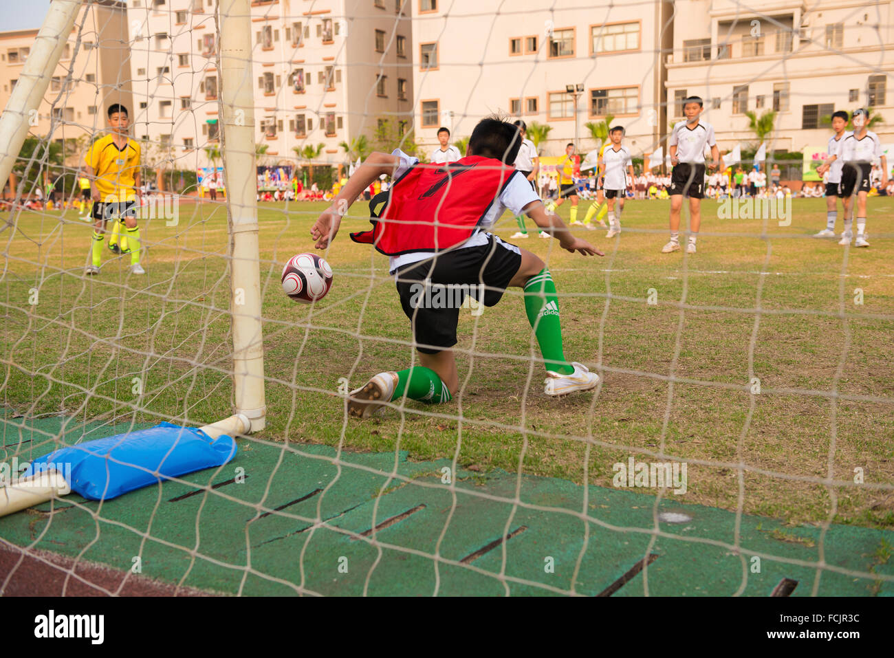 ZHONGSHAN, CHINA - MARCH 19 kids playing at a friendly soccer game on March 19, 2015 in Zhongshan, China. Stock Photo