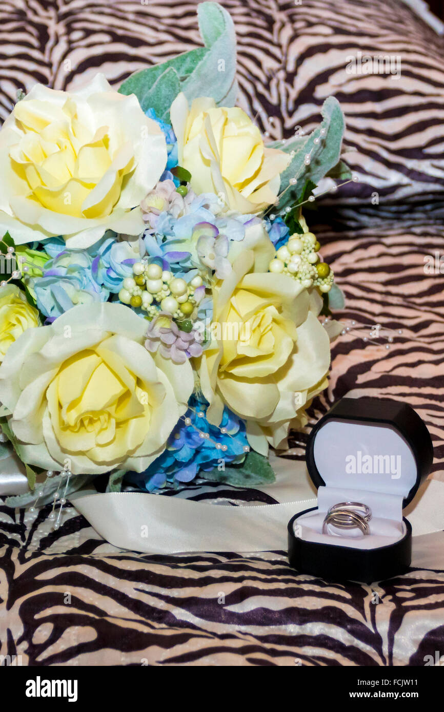 A bouquet of flowers as symbol from an union and circlets in marriage Stock Photo