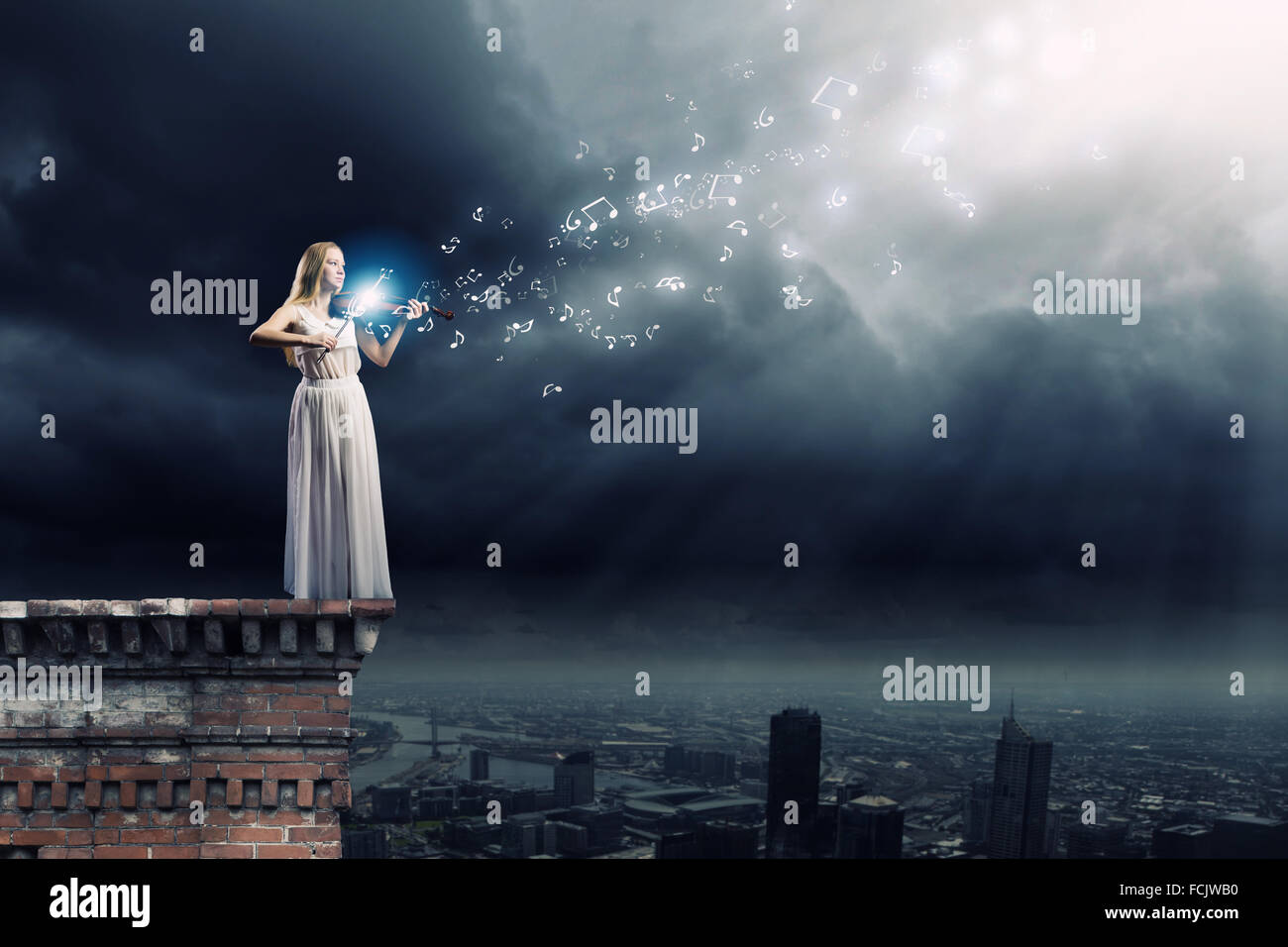 Young woman in white dress playing violin Stock Photo - Alamy