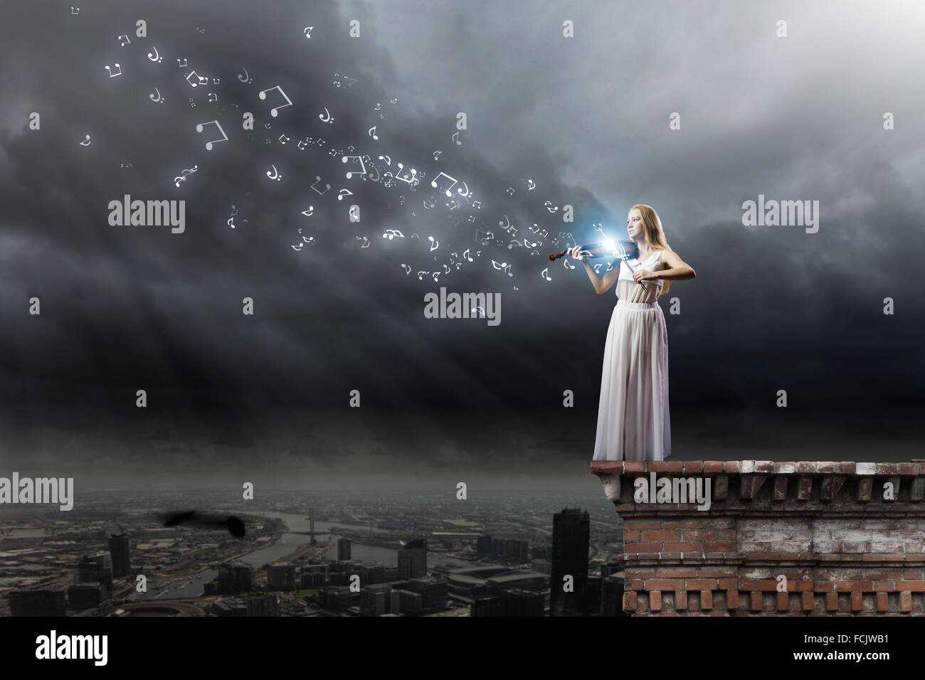 Young woman in white dress playing violin Stock Photo - Alamy