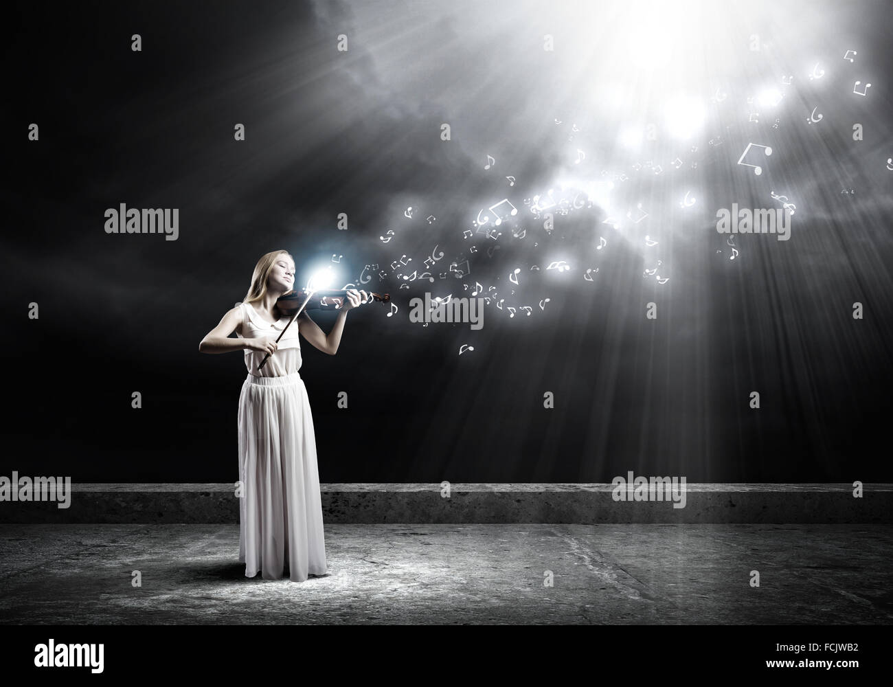 Young woman in white dress playing violin Stock Photo - Alamy