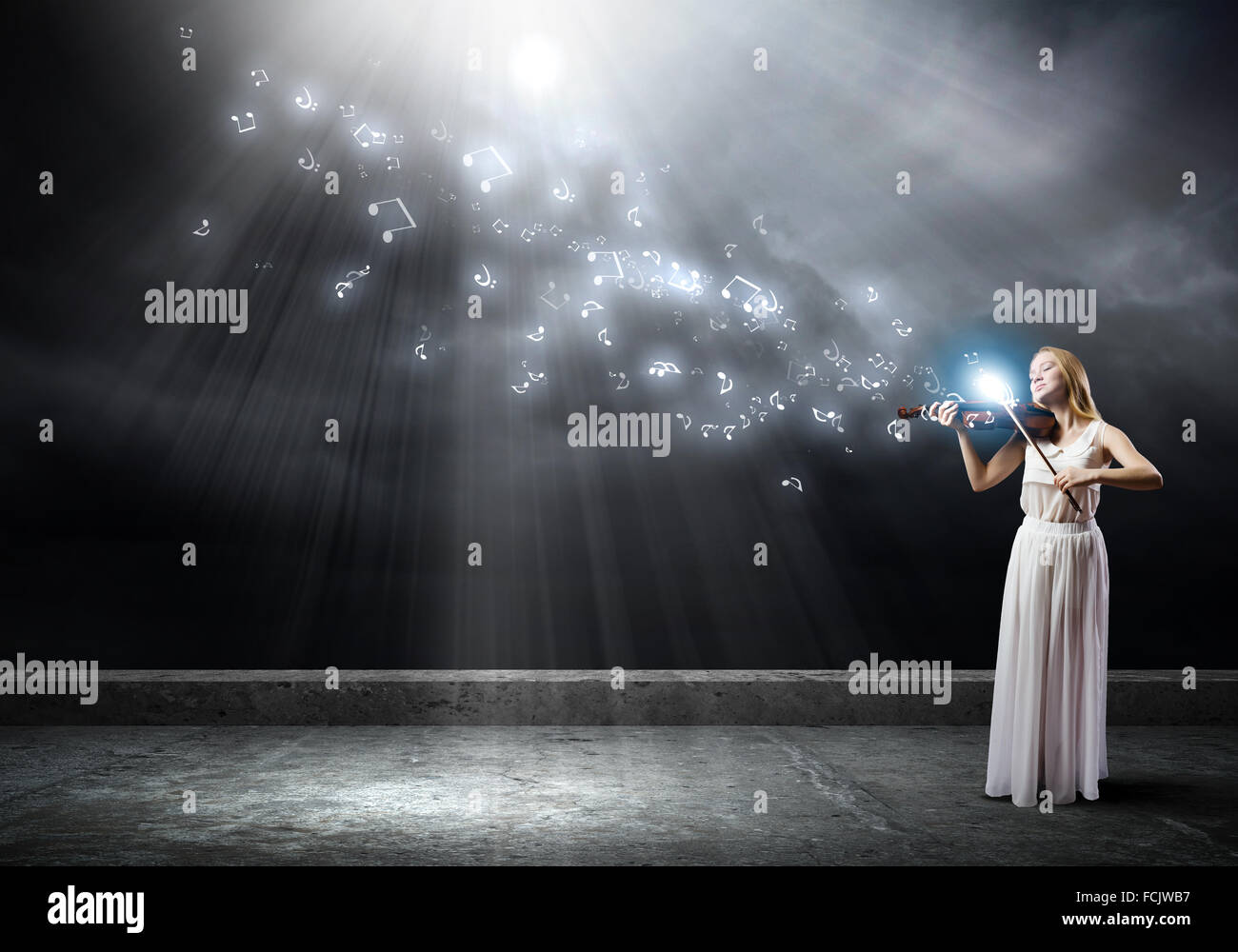 Young woman in white dress playing violin Stock Photo - Alamy