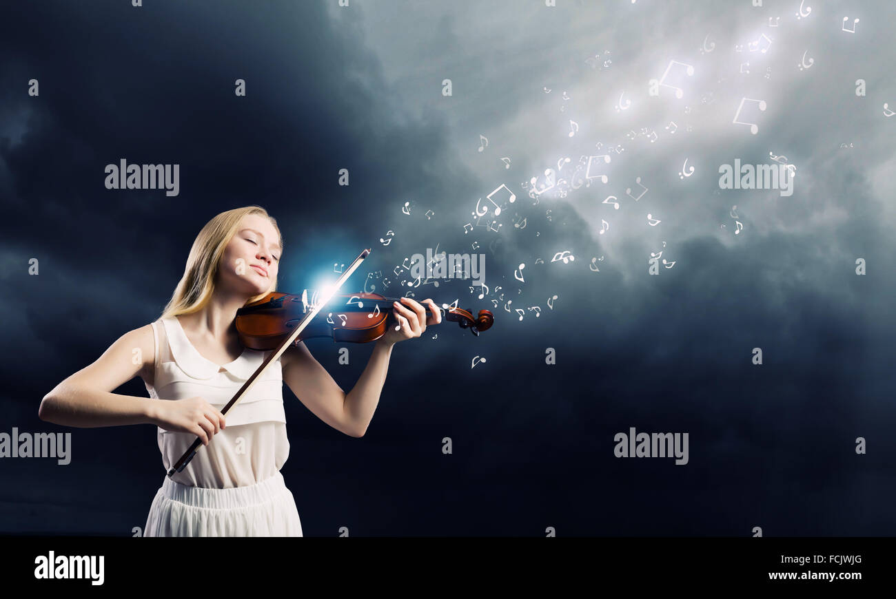 Young woman in white dress playing violin Stock Photo - Alamy
