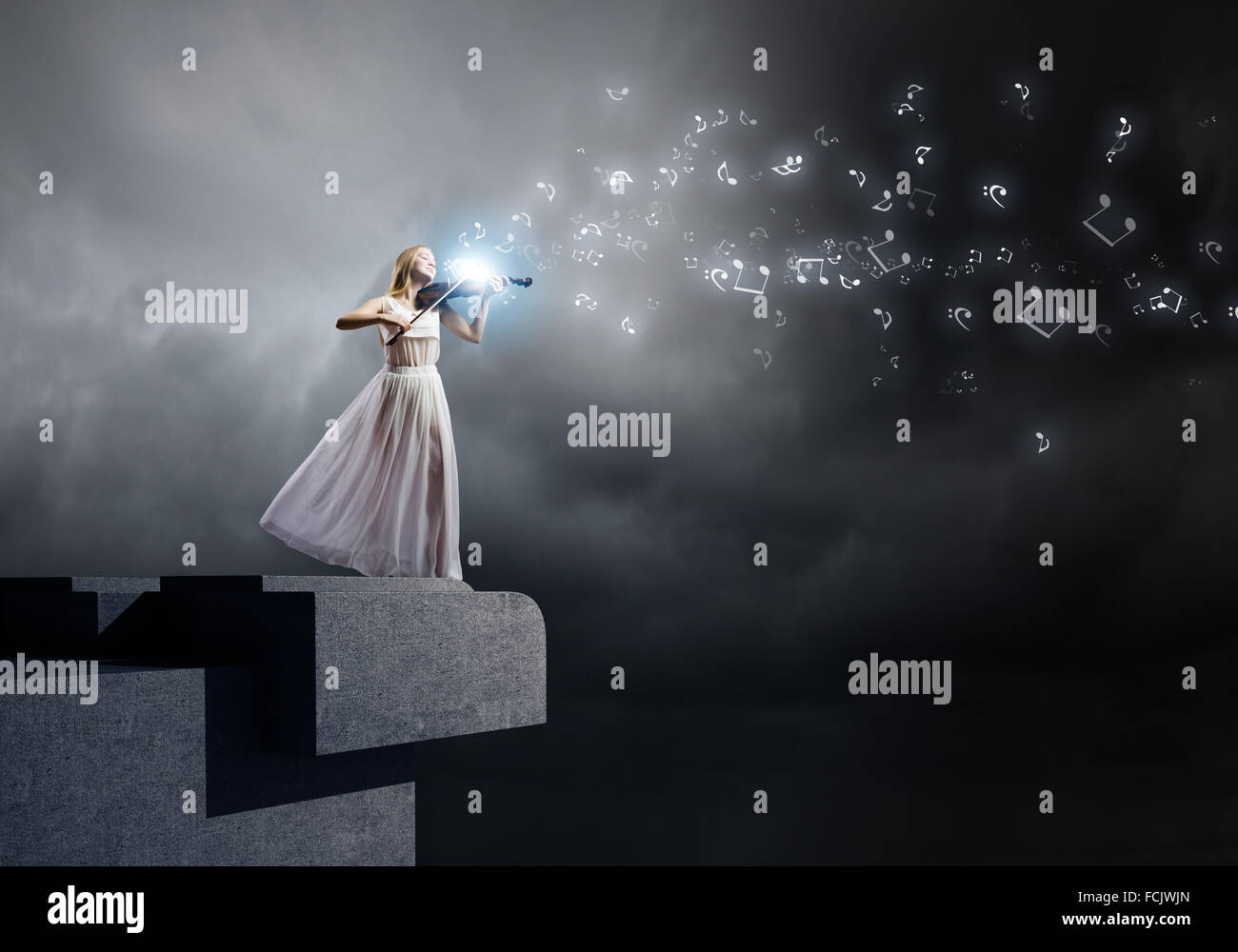 Young woman in white dress playing violin Stock Photo - Alamy