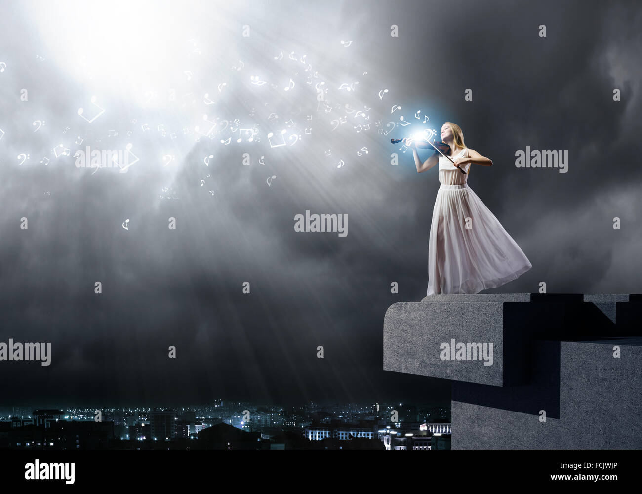 Young woman in white dress playing violin Stock Photo - Alamy