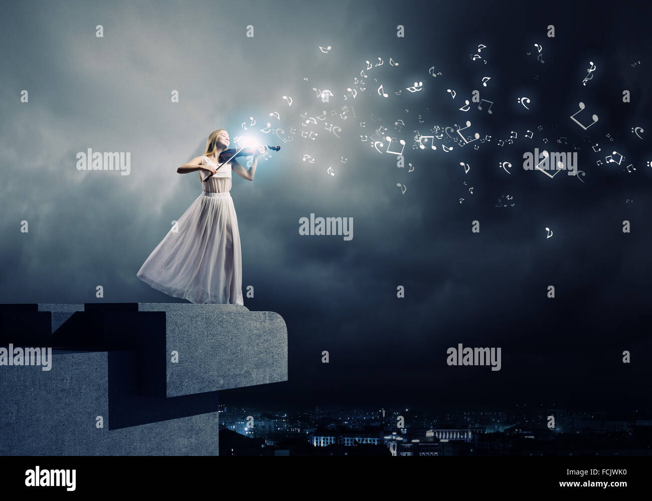 Young woman in white dress playing violin Stock Photo - Alamy
