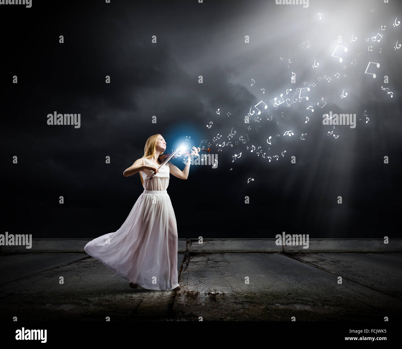 Young woman in white dress playing violin Stock Photo - Alamy