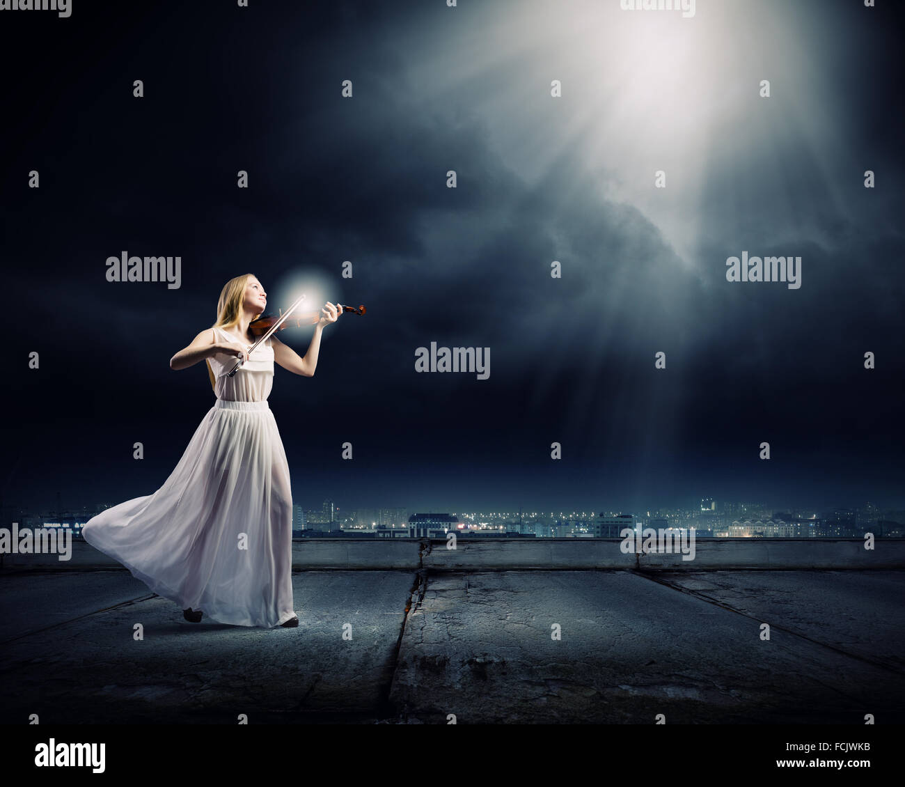 Young woman in white dress playing violin Stock Photo - Alamy