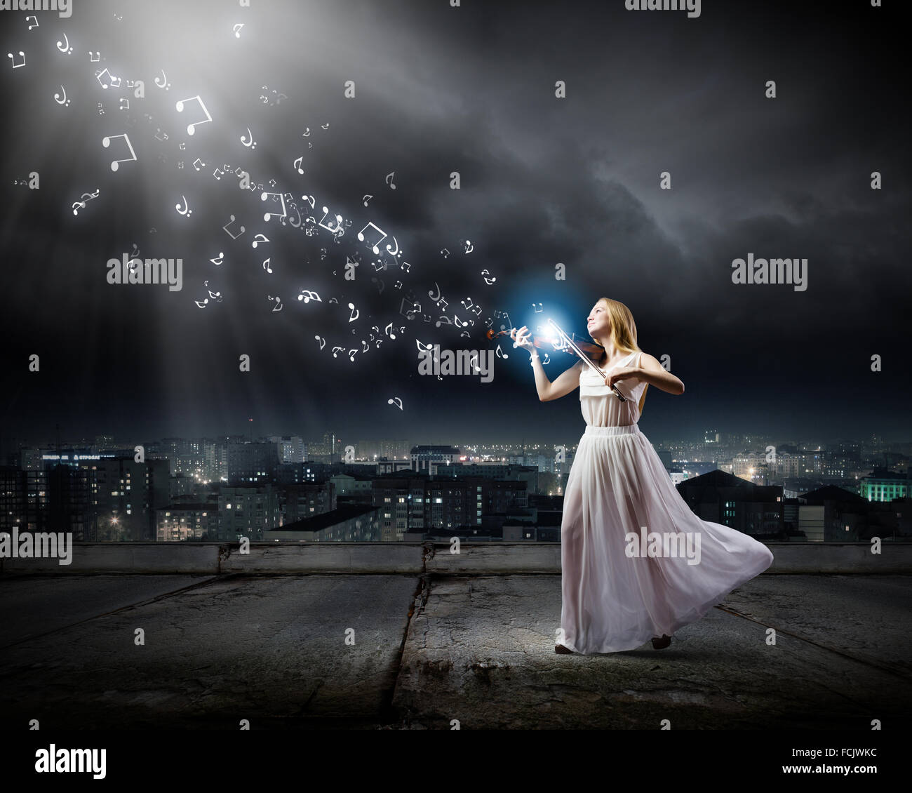 Young woman in white dress playing violin Stock Photo - Alamy