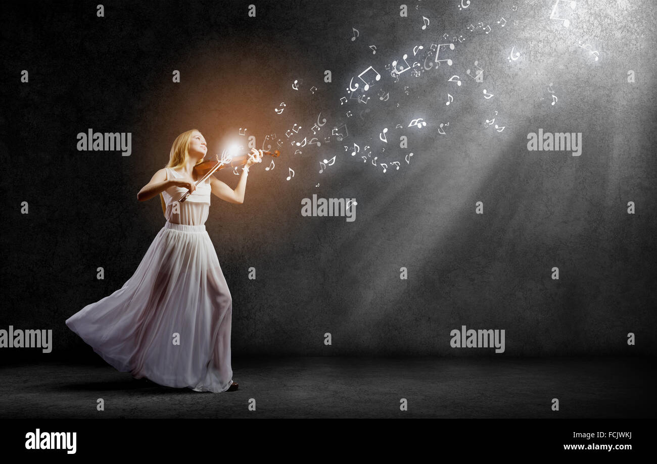 Young woman in white dress playing violin Stock Photo - Alamy