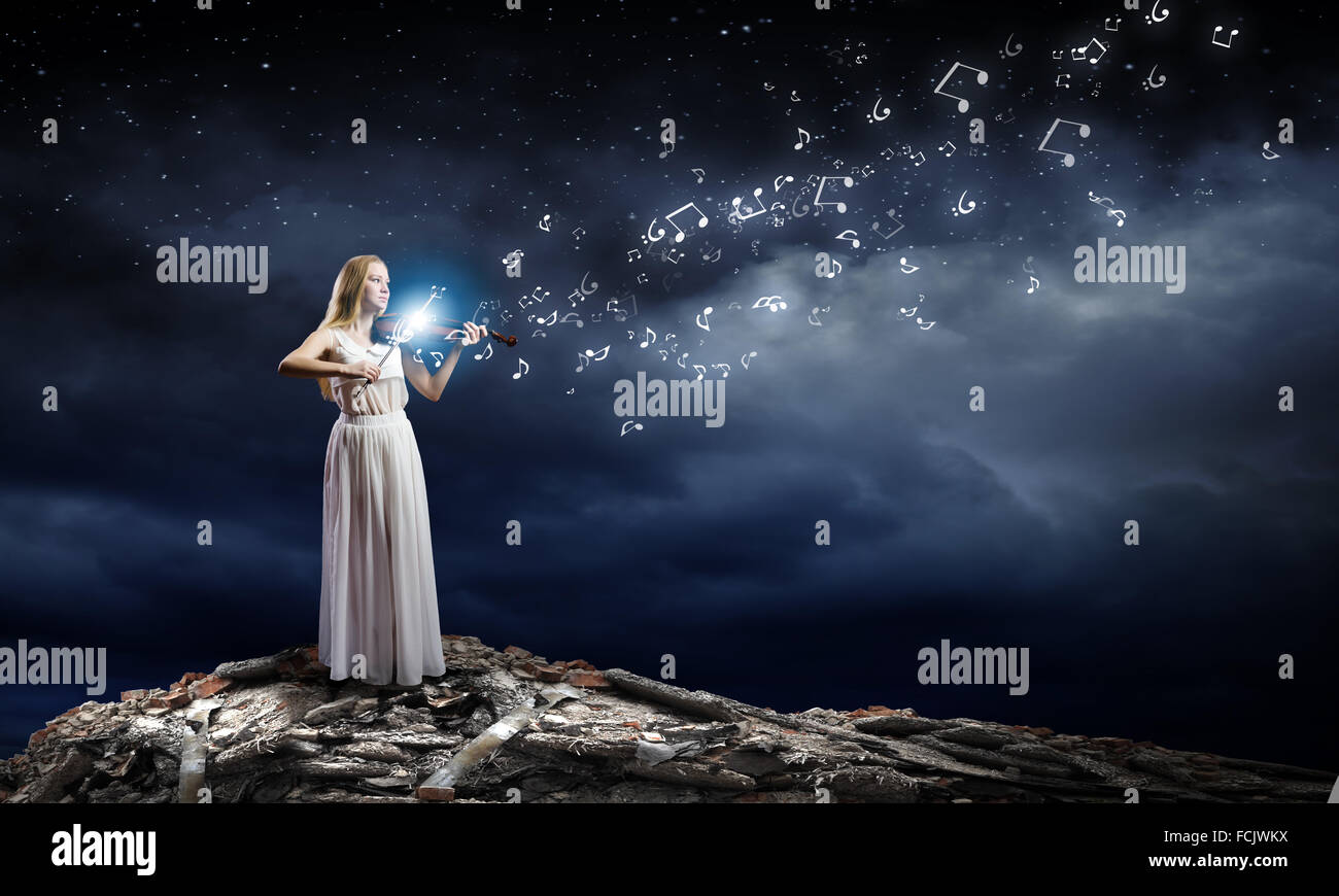 Young woman in white dress playing violin Stock Photo - Alamy