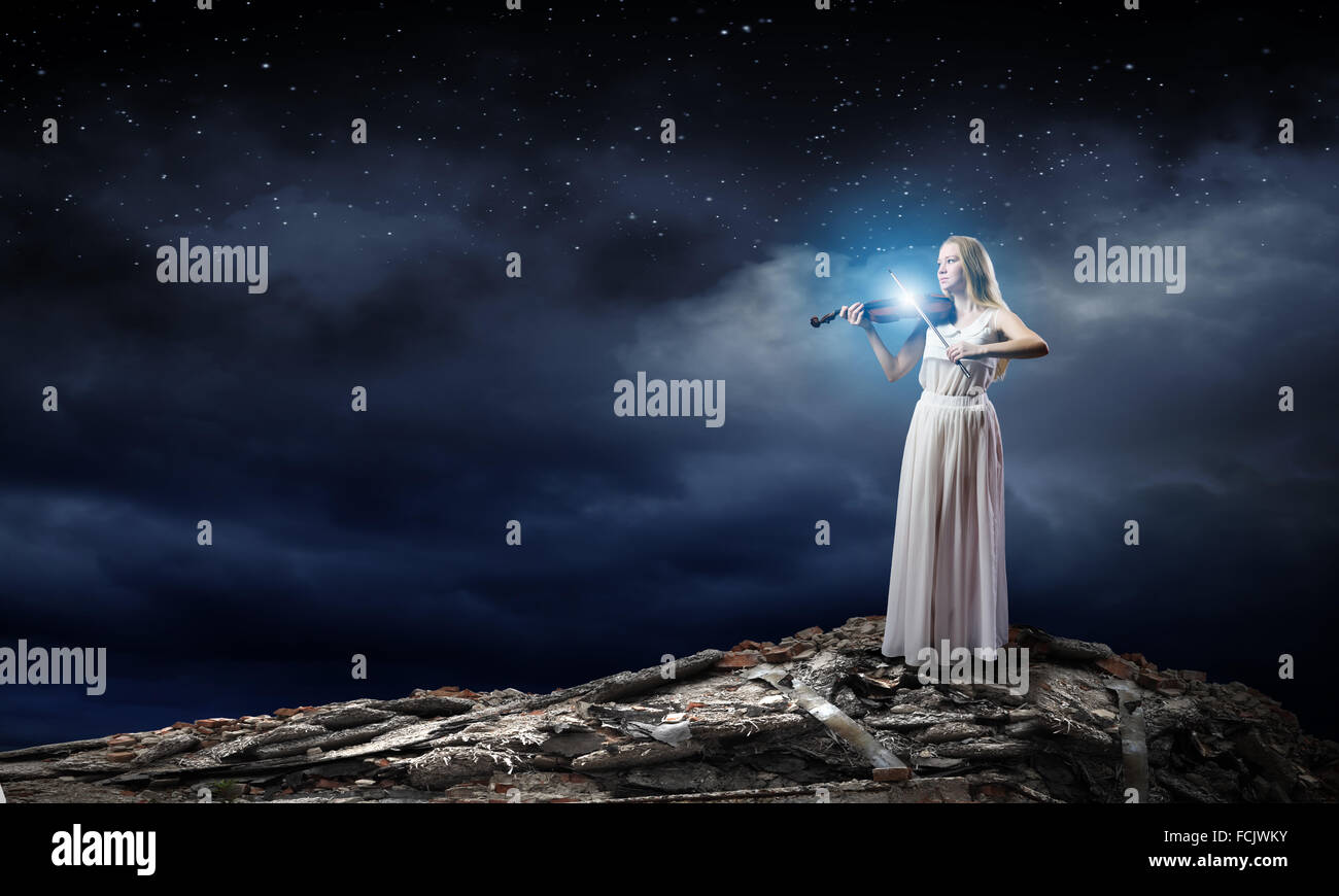 Young woman in white dress playing violin Stock Photo - Alamy