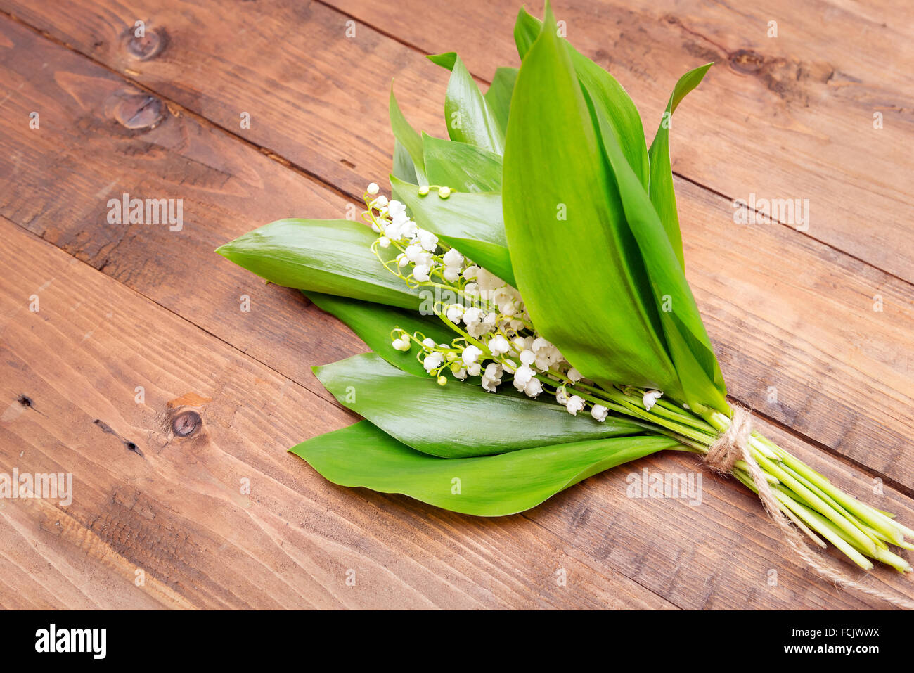 Bouquet of lily of the valley on wooden background Stock Photo - Alamy