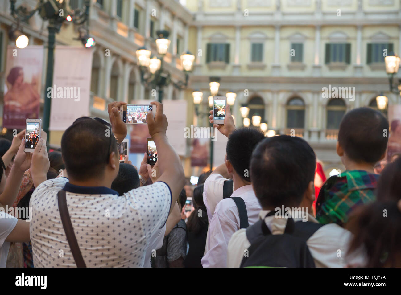 Macao, China - June 25, 2015:People watching a live show taking photos and videos in Venetian Hotel, Macao on June 25, 2015. The Stock Photo