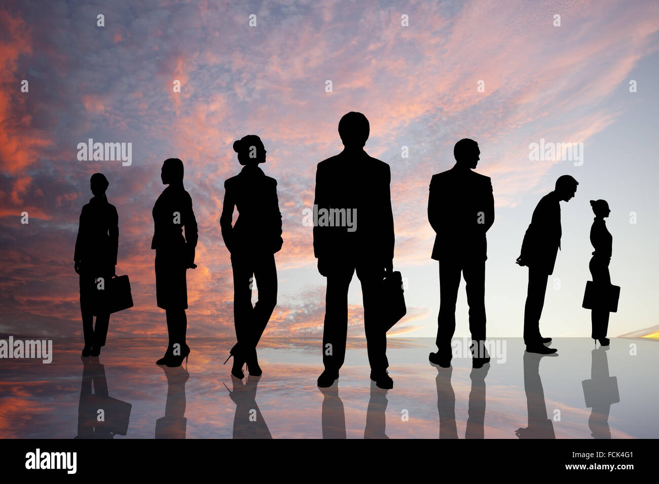Silhouettes of business people against sunset landscape Stock Photo - Alamy