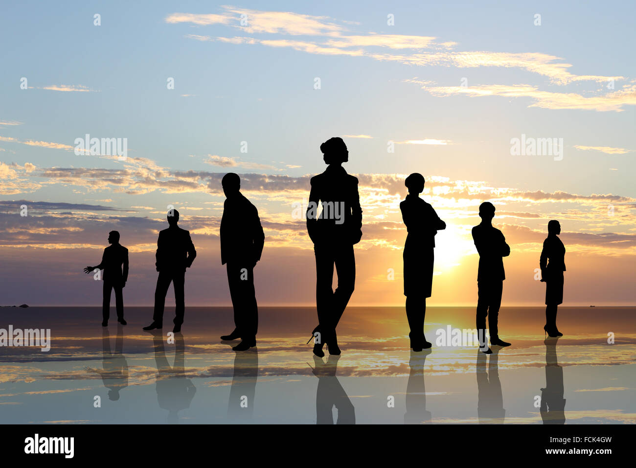 Silhouettes of business people against sunset landscape Stock Photo - Alamy
