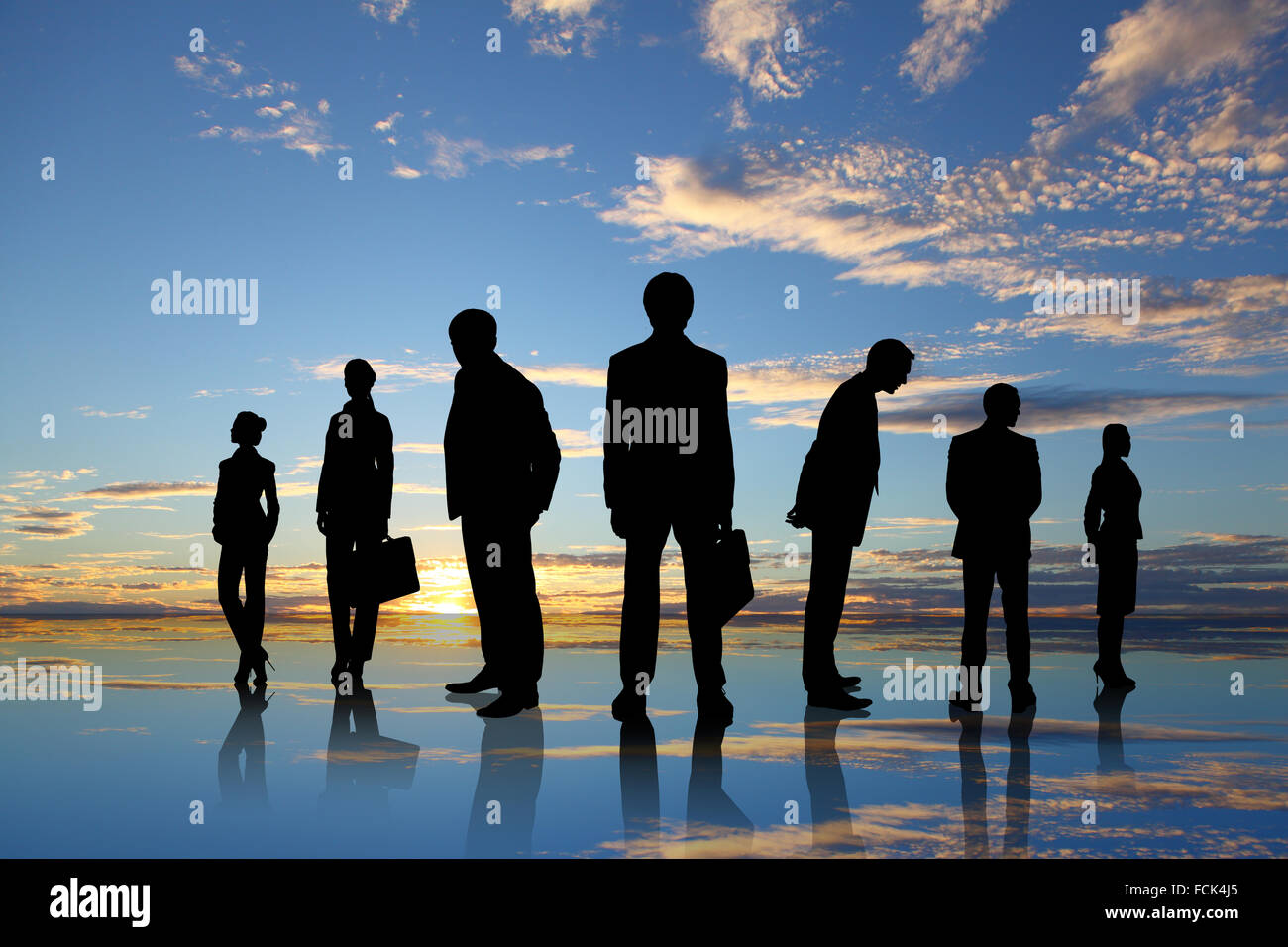 Silhouettes of business people against sunset landscape Stock Photo - Alamy
