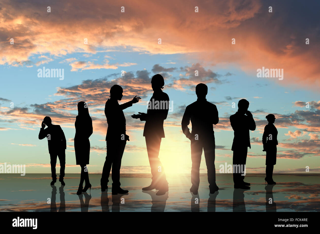 Silhouettes of business people against sunset landscape Stock Photo - Alamy
