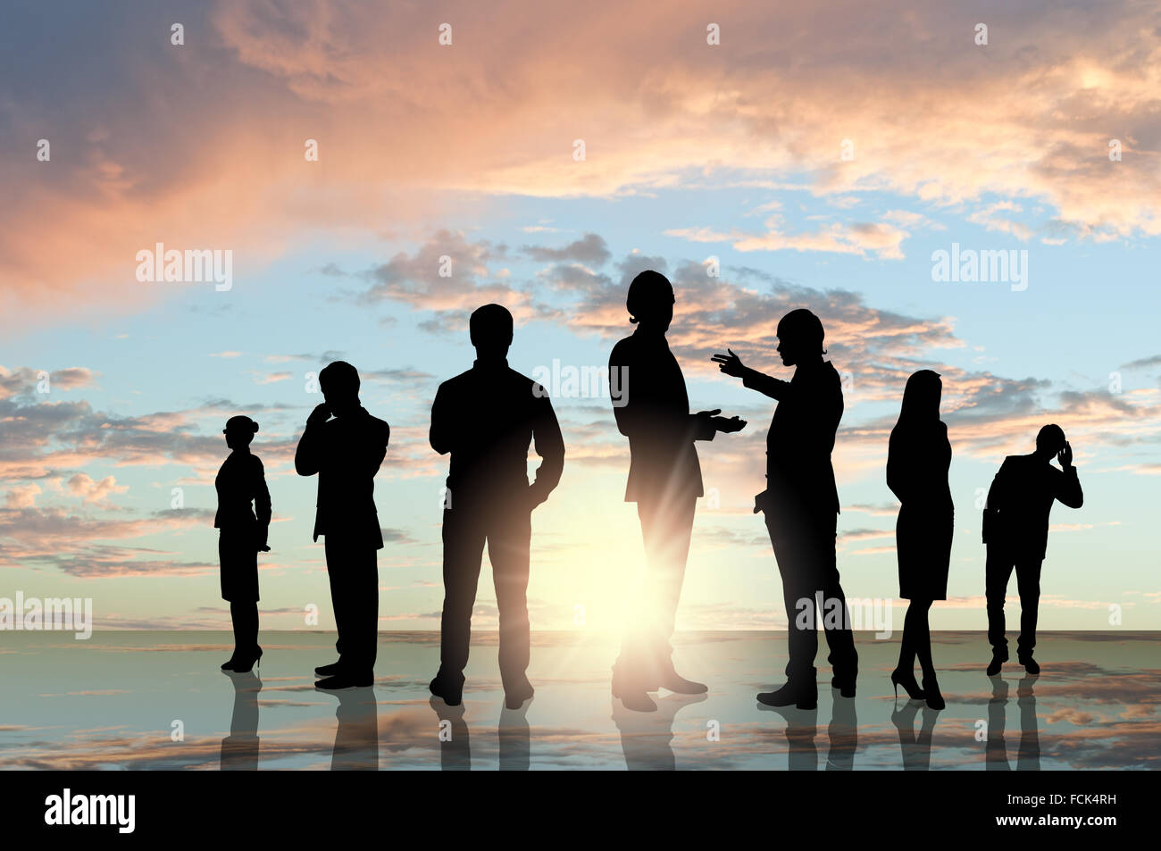 Silhouettes of business people against sunset landscape Stock Photo - Alamy