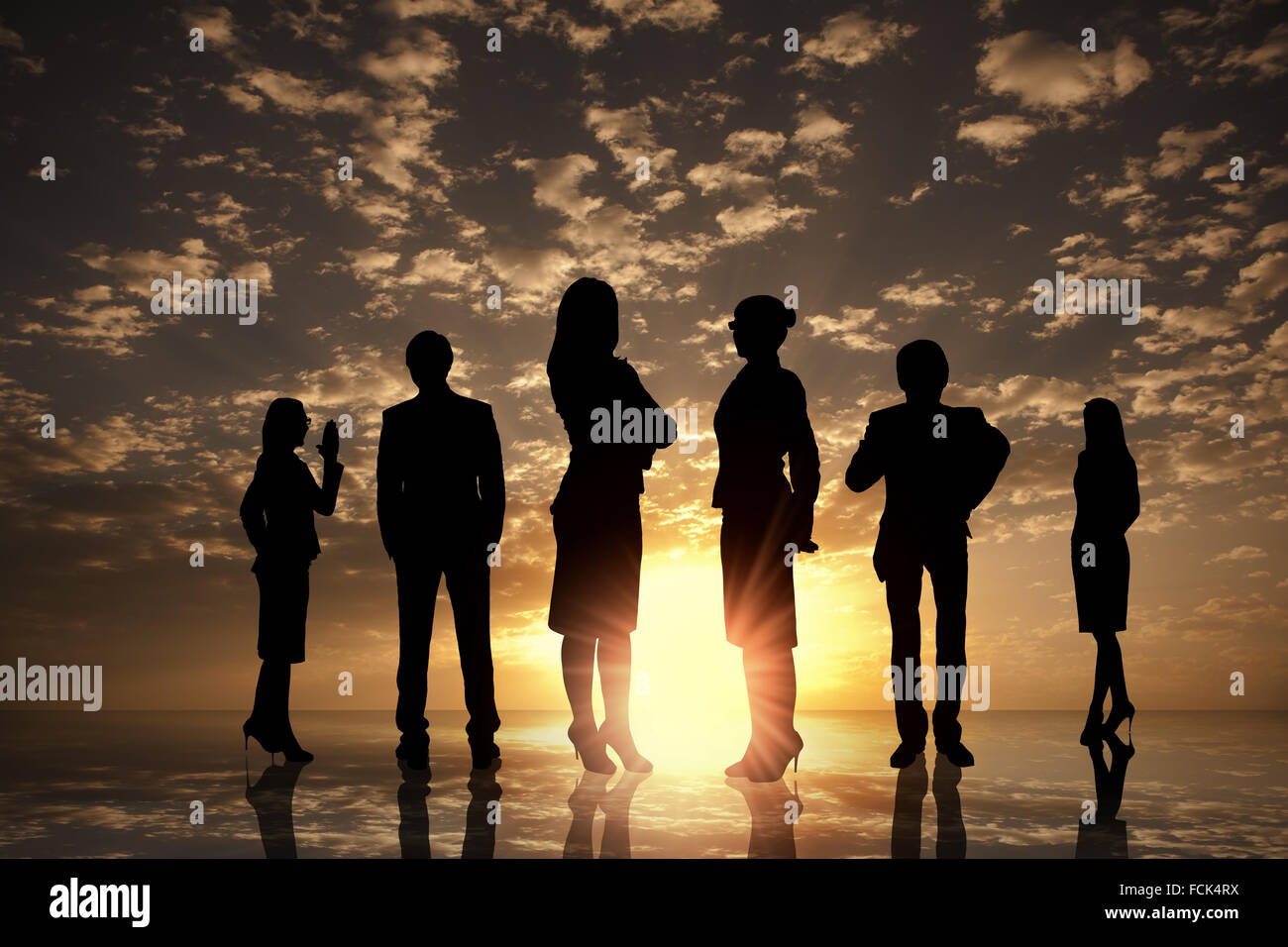 Silhouettes of business people against sunset landscape Stock Photo - Alamy