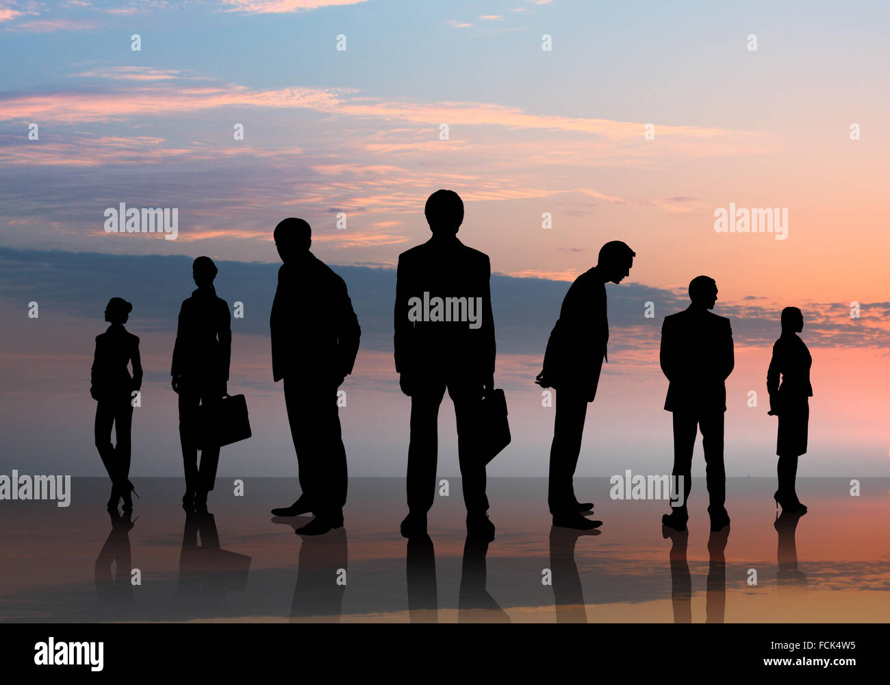 Silhouettes of business people against sunset landscape Stock Photo - Alamy