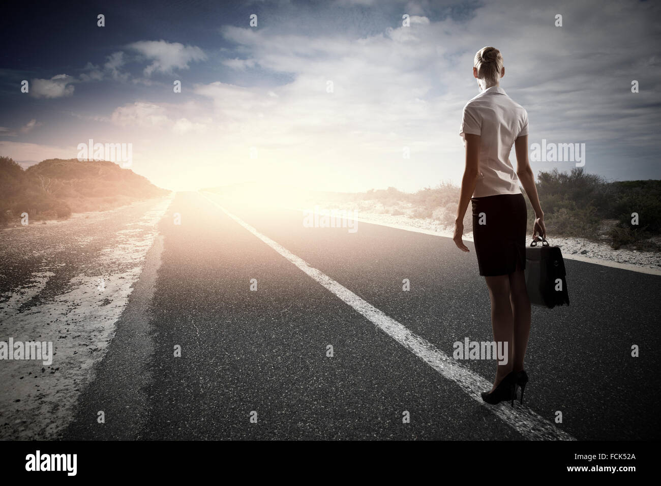 Rear view of businesswoman standing on road Stock Photo - Alamy