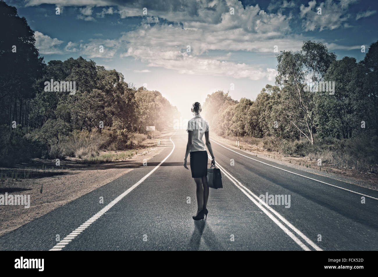 Rear view of businesswoman standing on road Stock Photo - Alamy