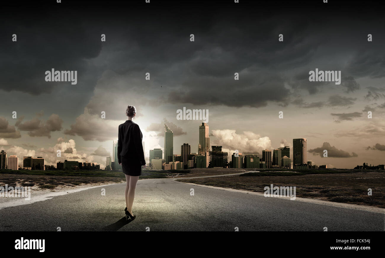 Rear view of businesswoman standing on road Stock Photo - Alamy