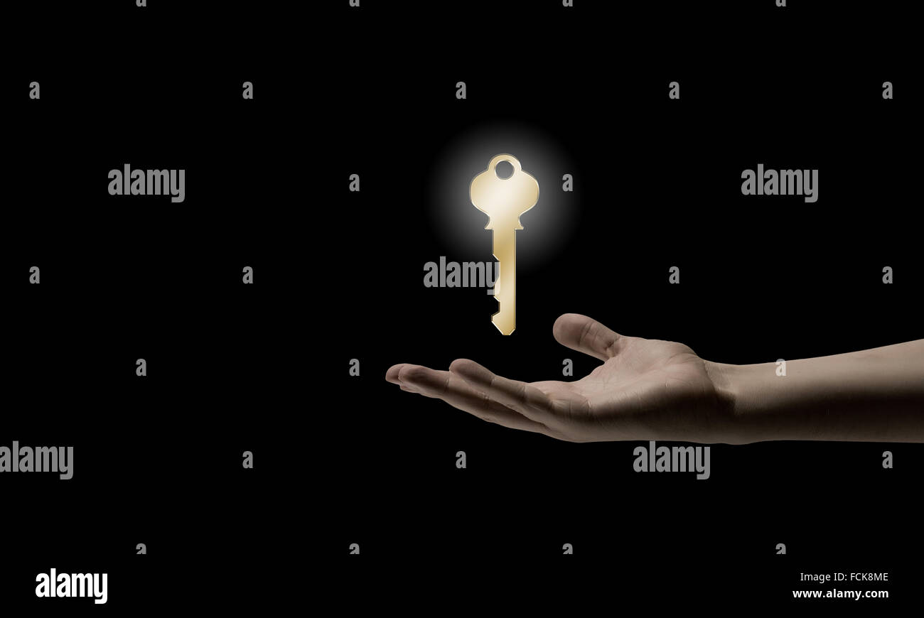 Close up of human hand holding golden key Stock Photo - Alamy