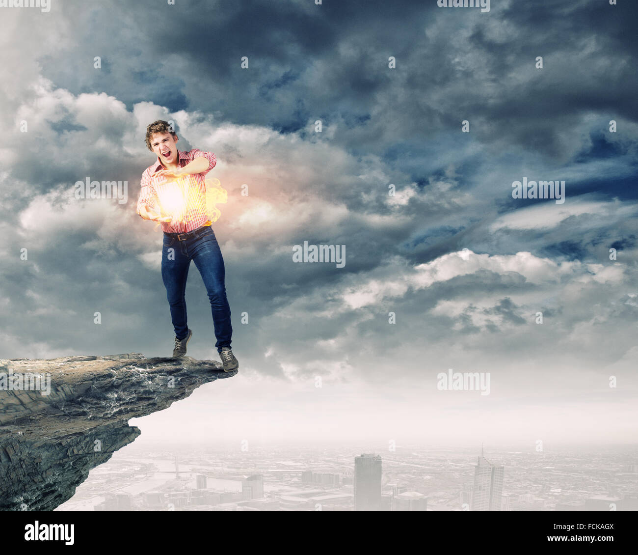 Young man in casual throwing magic fire balls Stock Photo Alamy