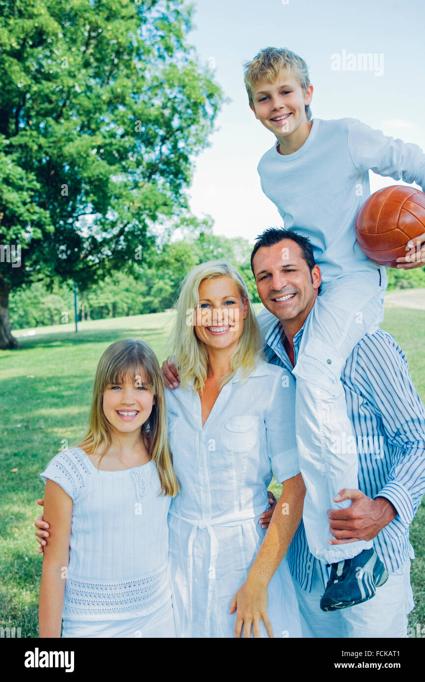Portrait of happy family in a park Stock Photo - Alamy