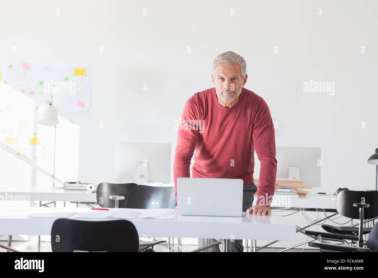 Portrait of confident businessman   laptop in office Stock Photo