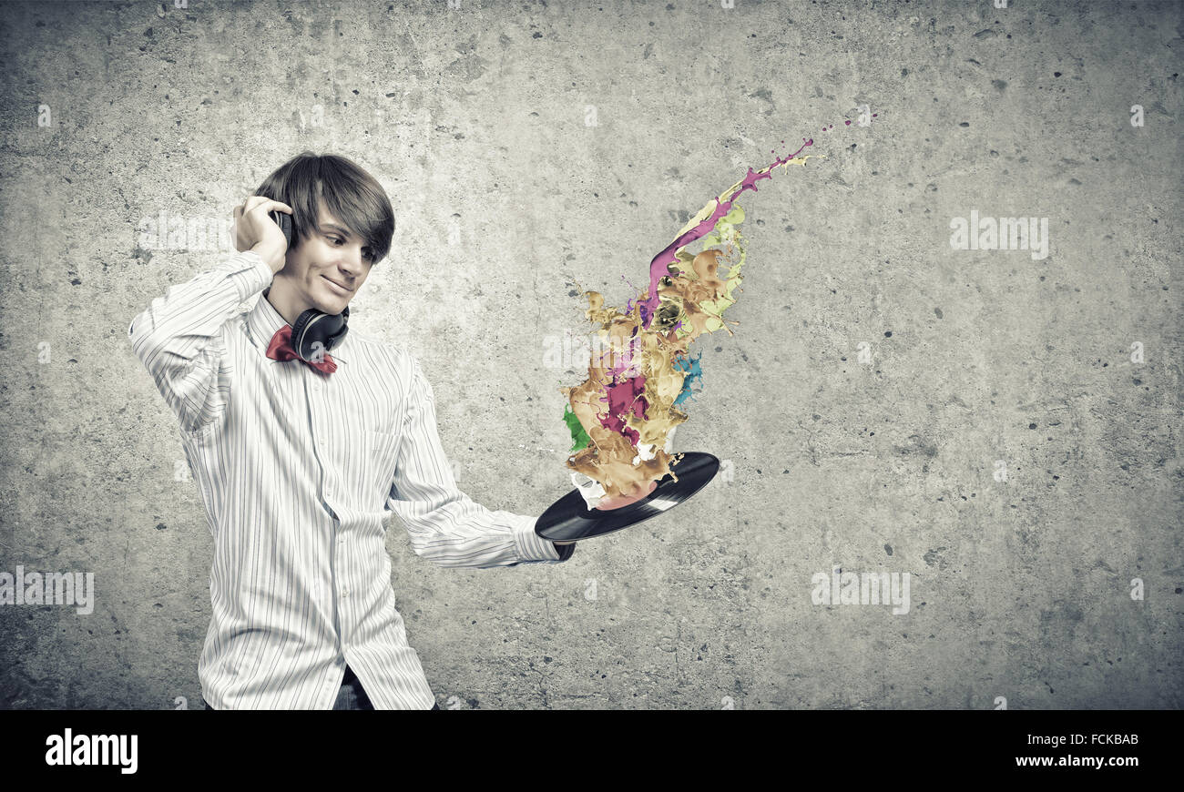 Young man dj wearing headphones and holding plate Stock Photo Alamy