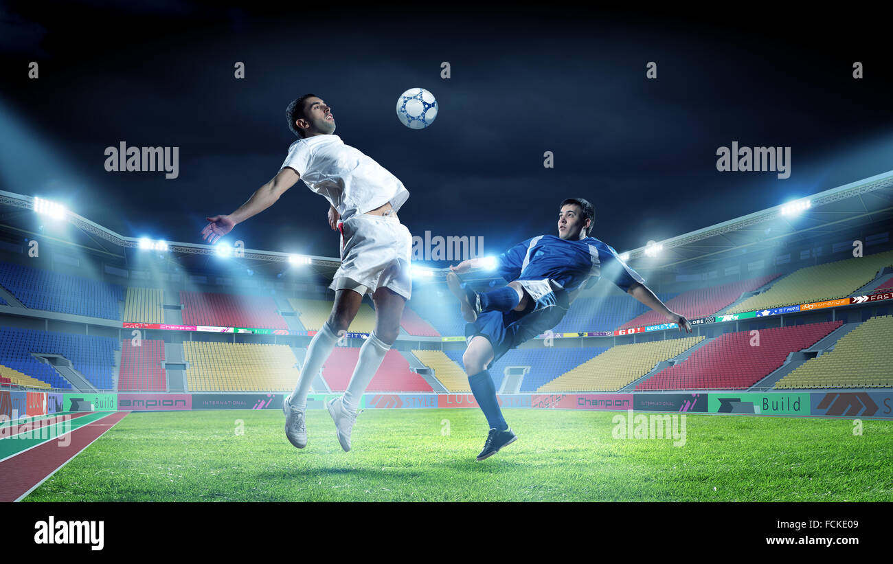 Field Fight Two football player fighting for ball at stadium Stock Photo - Alamy