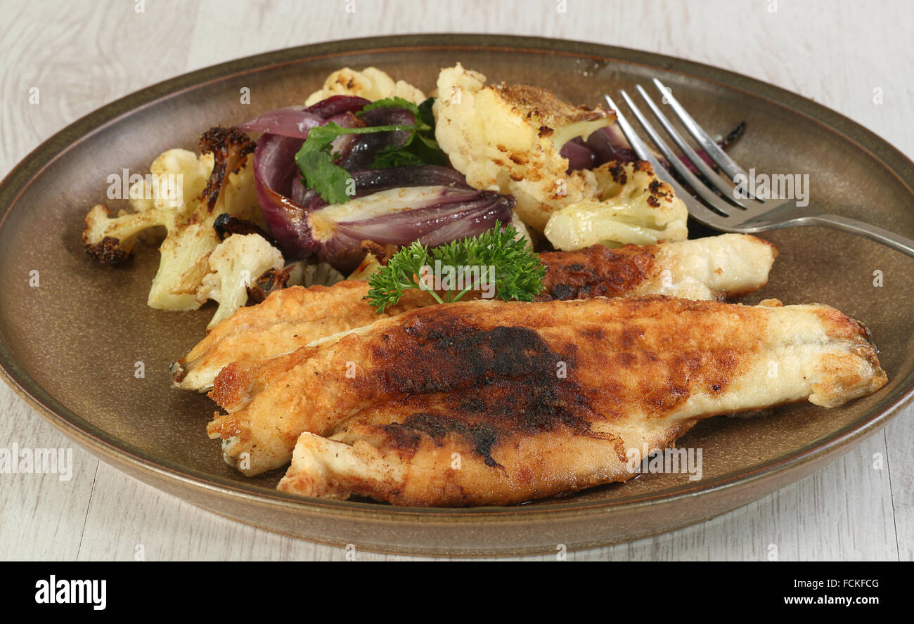 pan fried sea bass fillets with roast cauliflower and red onion Stock