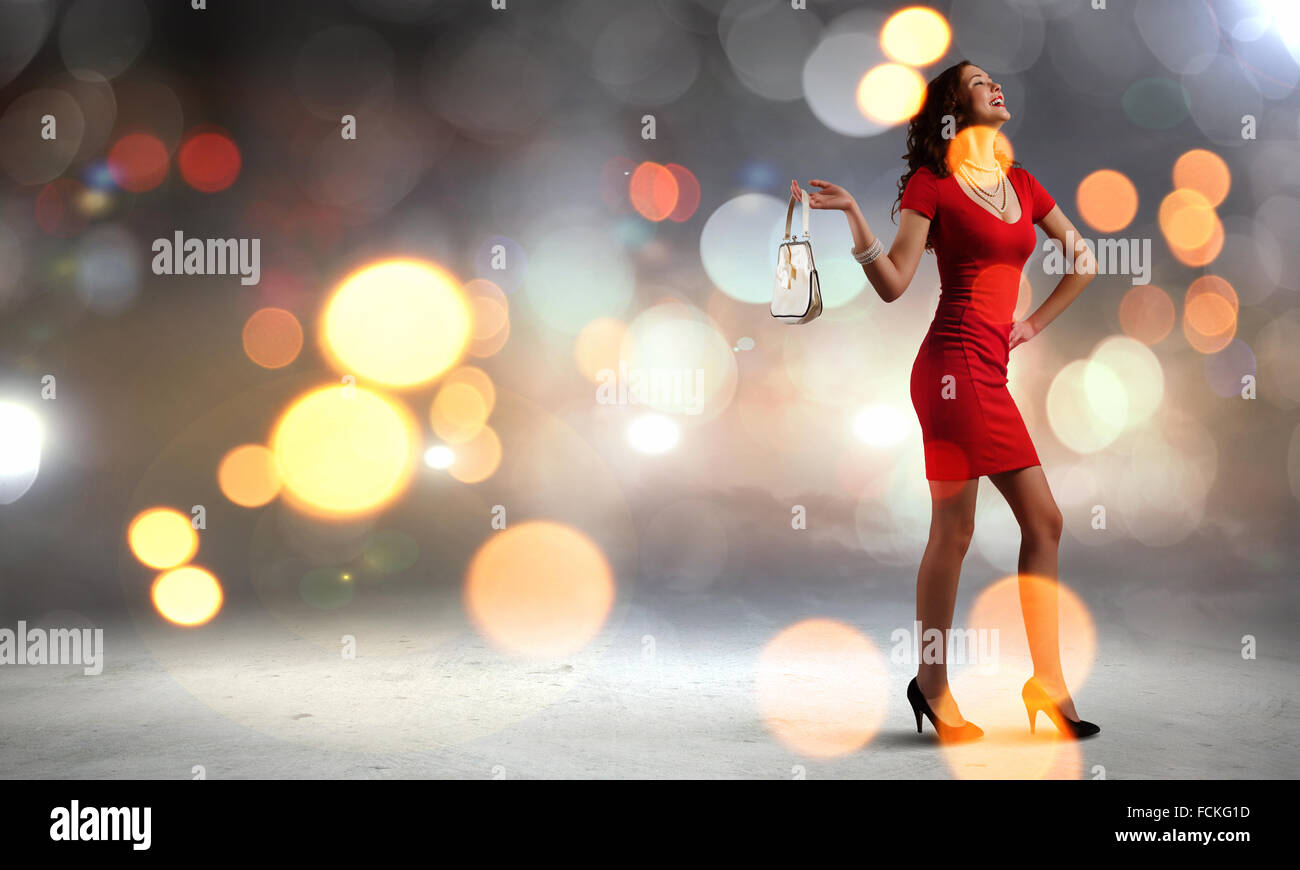 Young attractive woman in red dress with bag in hand Stock Photo Alamy
