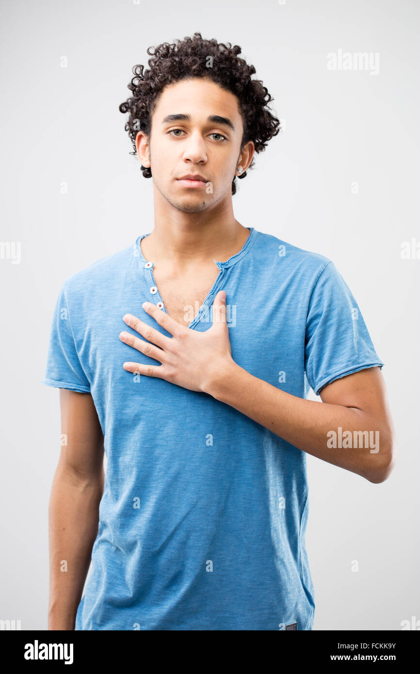young fascinating man with his hand on his chest meaning he's dedicated