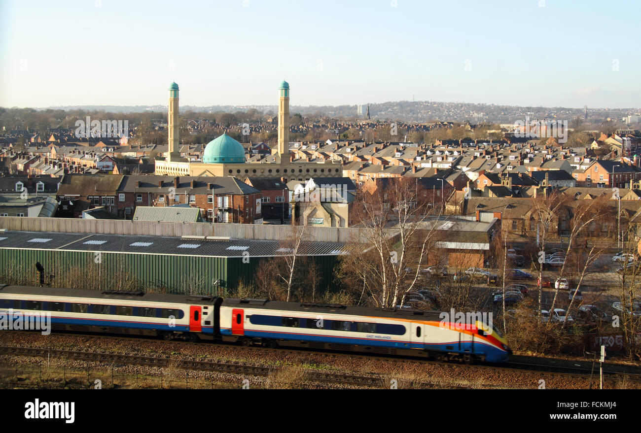 Sheffield featuring the main rail line into the city, the blue domes of the Madina Masjiid mosque and hills beyond, Yorkshire UK Stock Photo