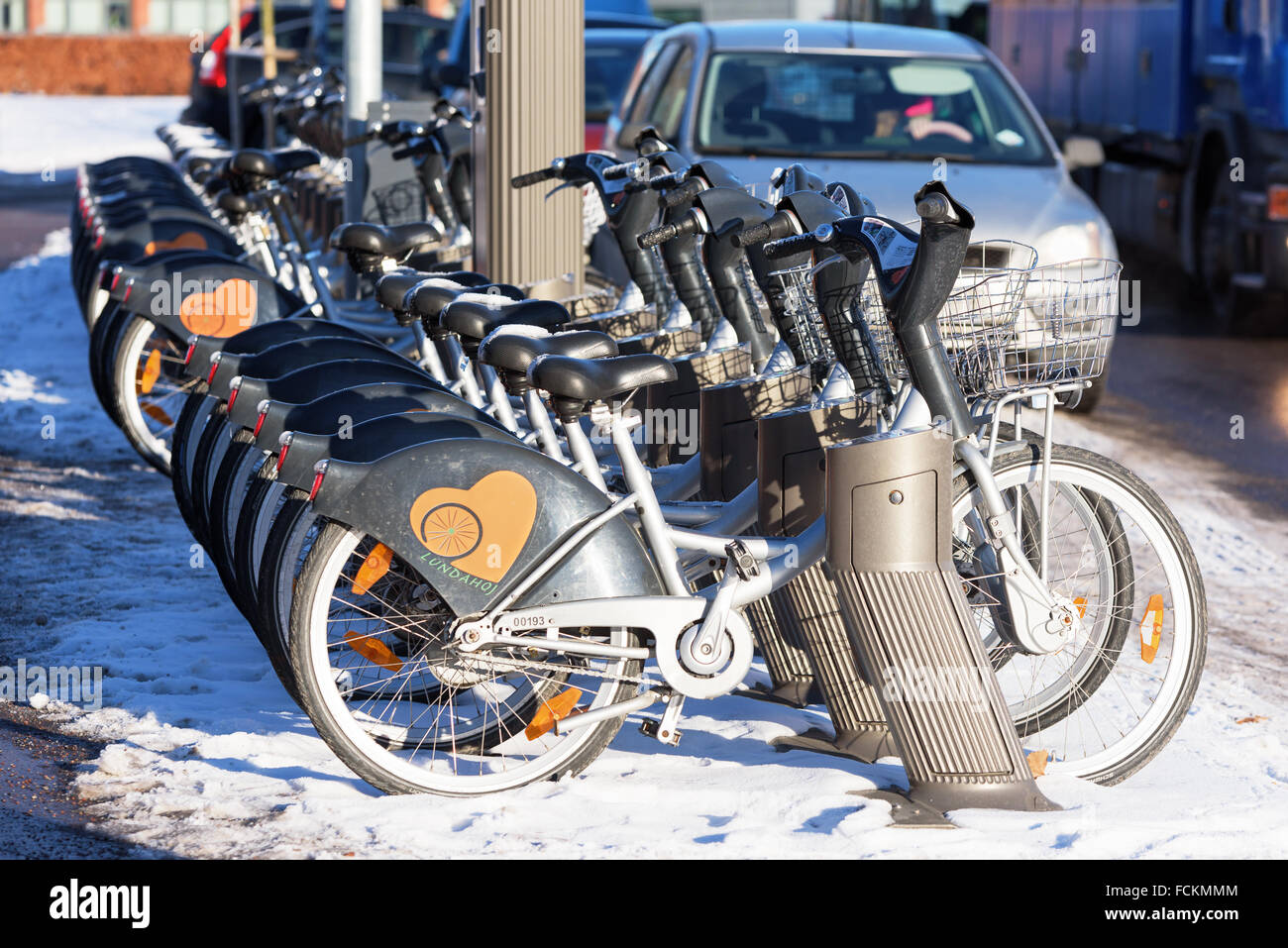 Lund, Sweden January 21, 2016 Rental bikes parked in winter urban landscape. Lundahoj has