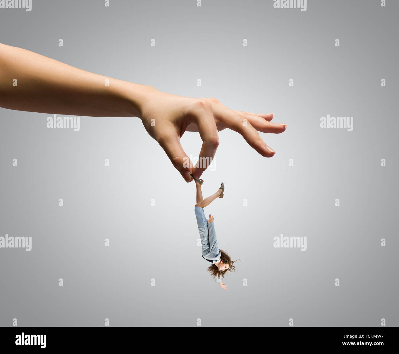 Giant human hand holding miniature of businesswoman Stock Photo - Alamy