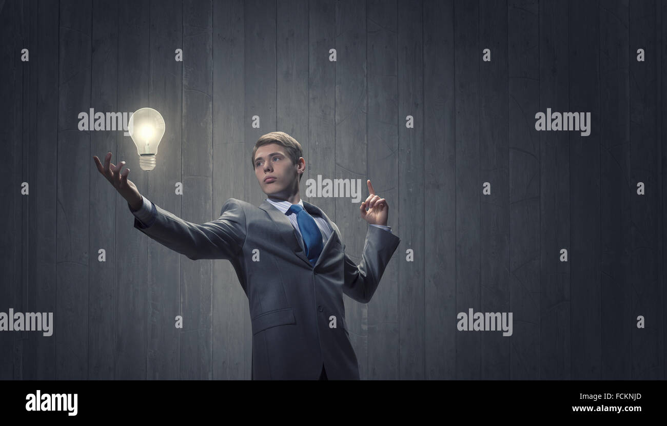 Young confident businessman and light bulb above his head Stock Photo ...