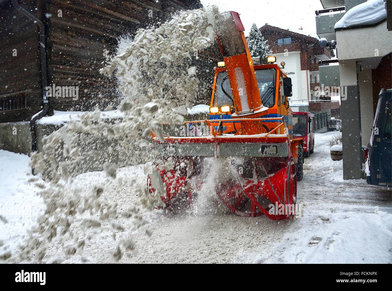Snow removal from street of Swiss ski resort SaasFee in heavy