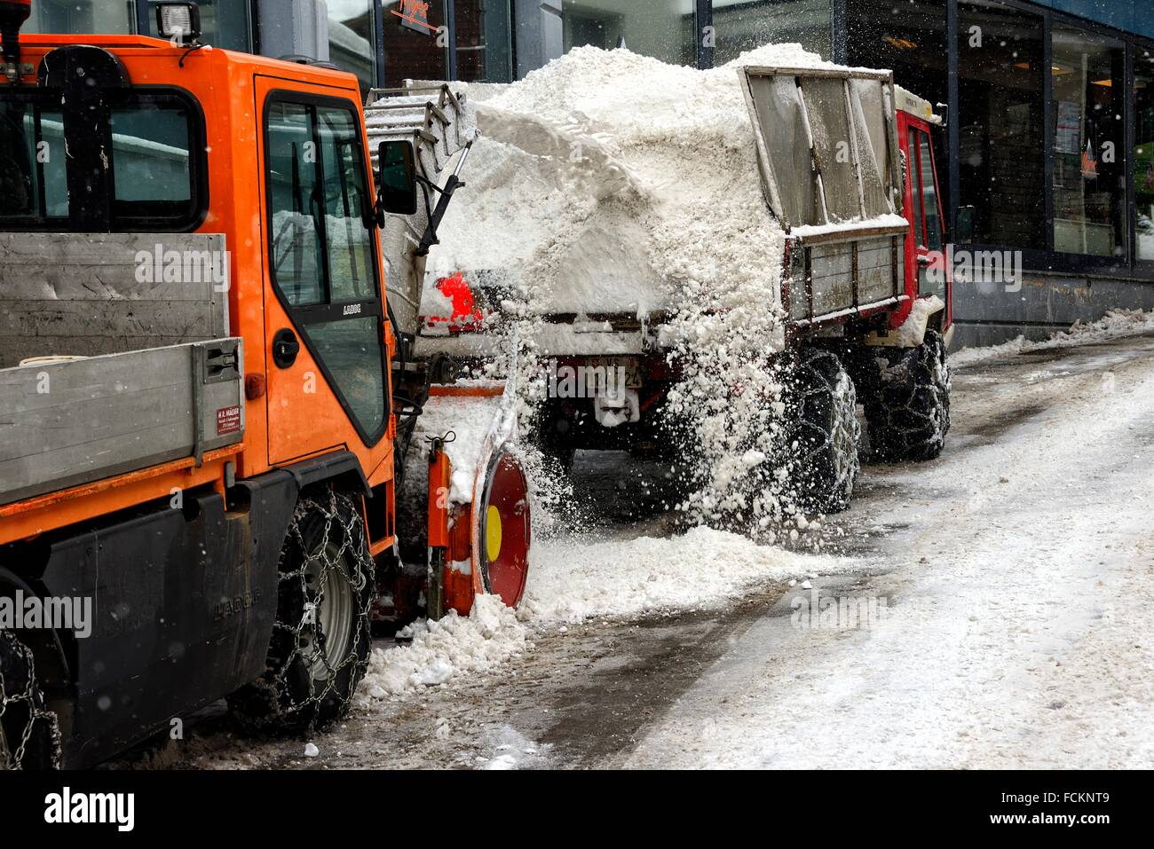 Snow removal from street of Swiss ski resort SaasFee, snowplow is