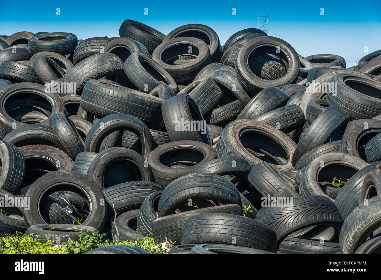 Old vehicle tyres dumped in piles. not biodegradable Stock Photo - Alamy