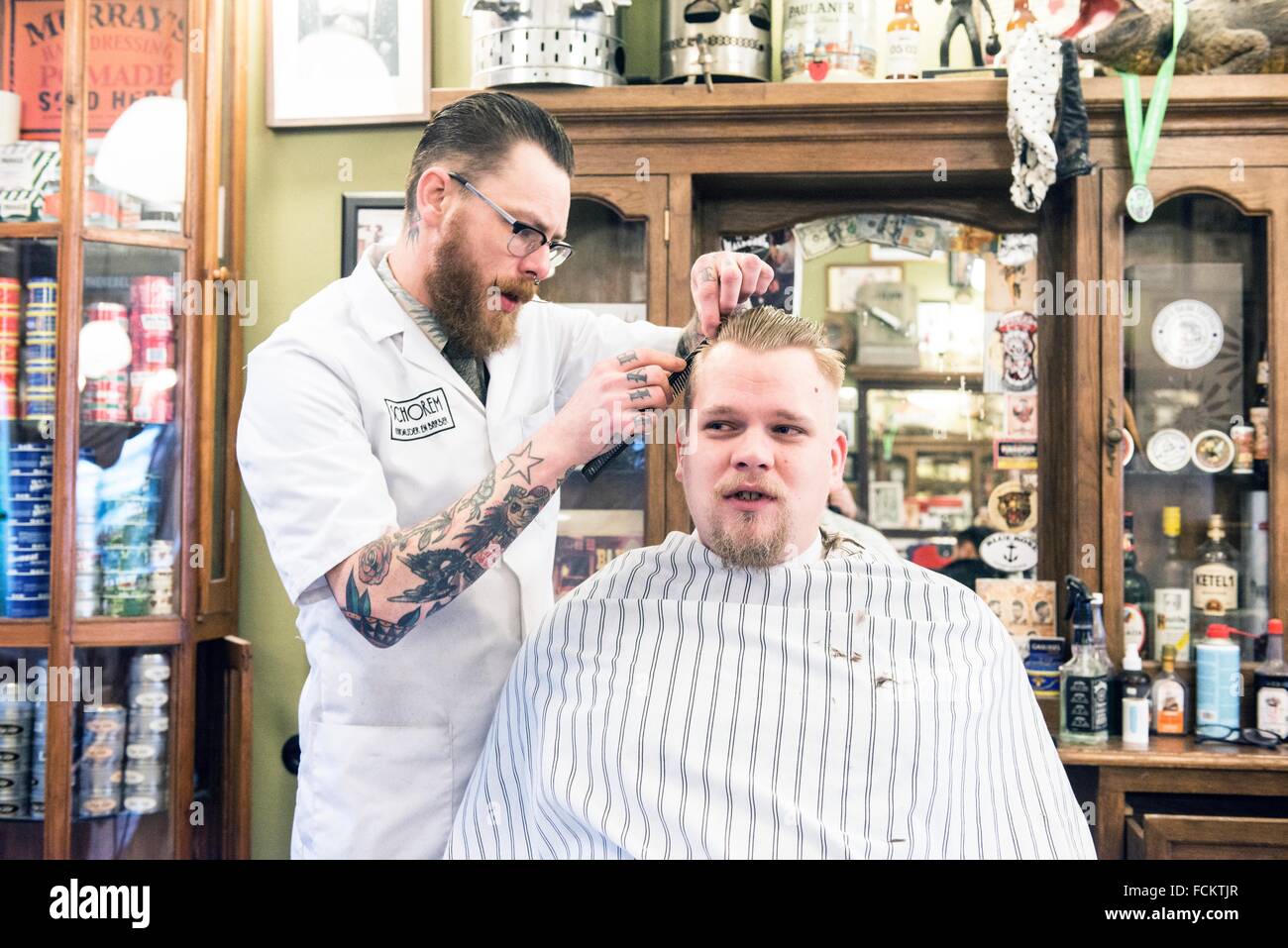 Rotterdam, Netherlands. Barber store Schorem. Barber helping his customer  in his barber shop by cutting and modeling his hair Stock Photo - Alamy