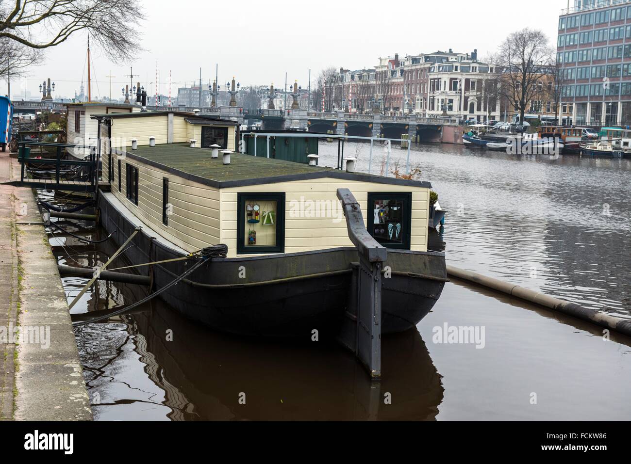 Amsterdam, Netherlands. Old barge, moored in the in the Amsterdam Canals, and in use as a houseboat. Stock Photo