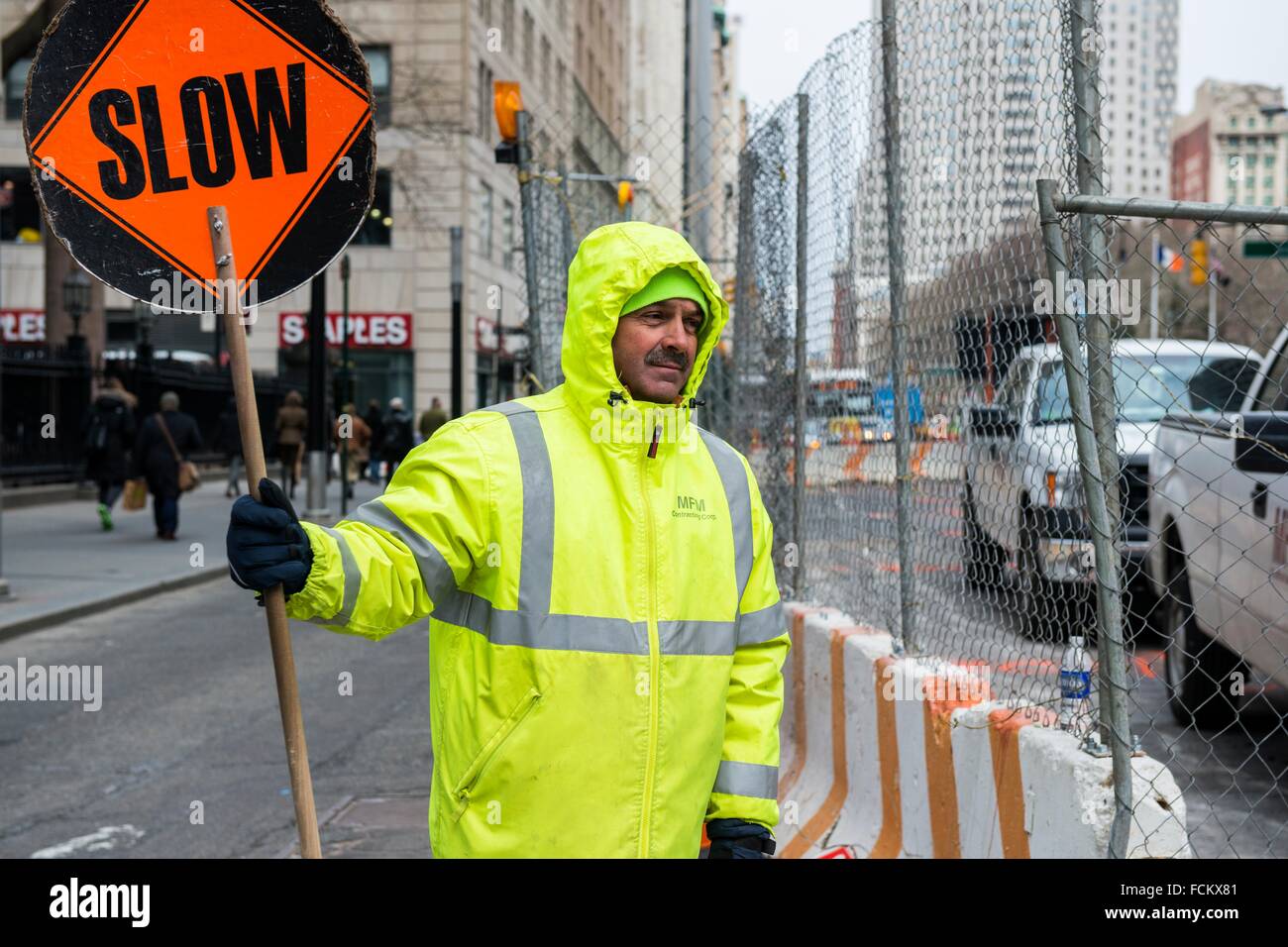 New York, USA. Male construction worker slowing down traffic near a